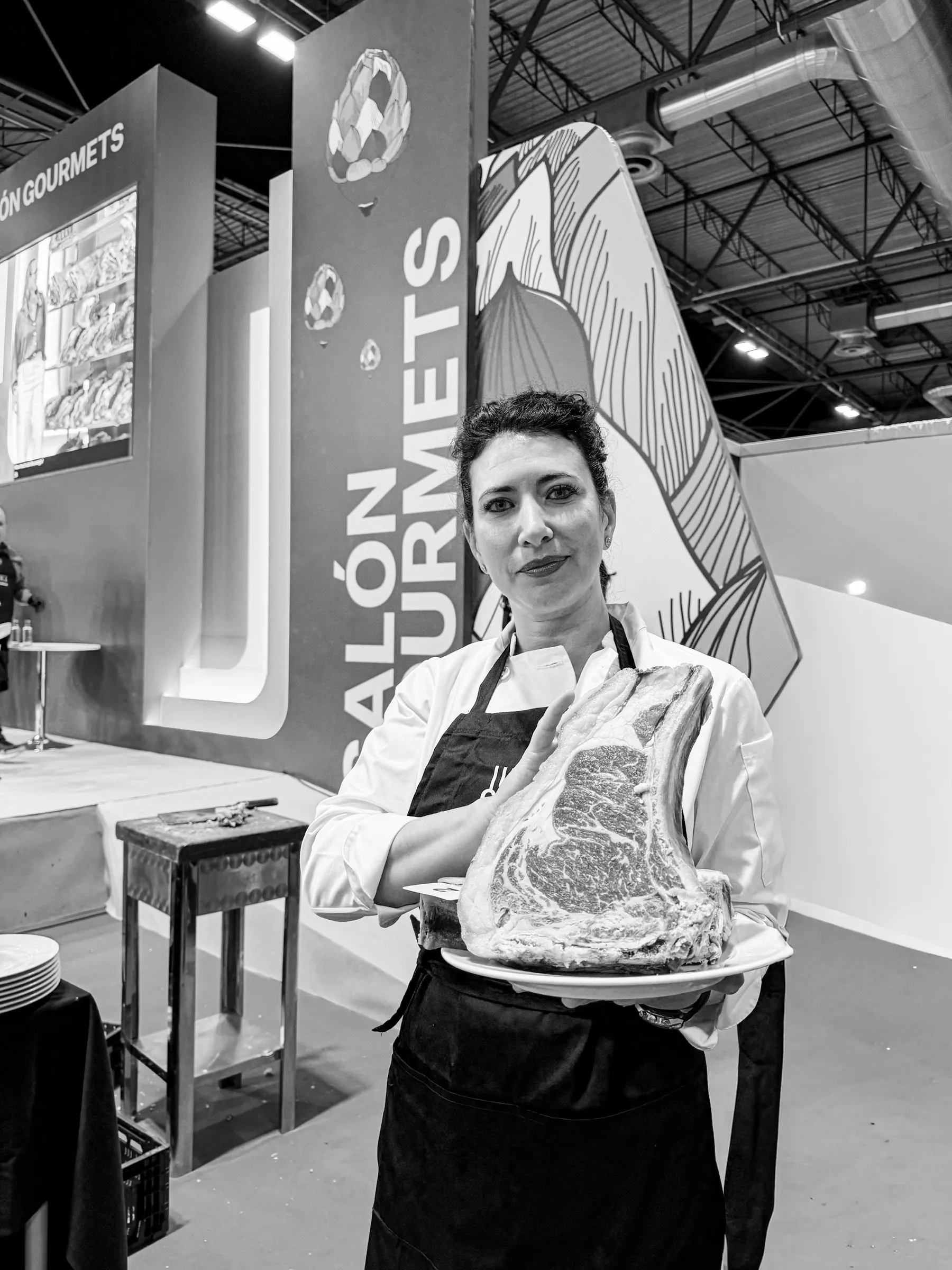 Retrato en blanco y negro de Davinia Martínez con un chuletón madurado